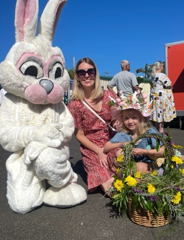 Easter Bunny with a family and a basket of native flowers
