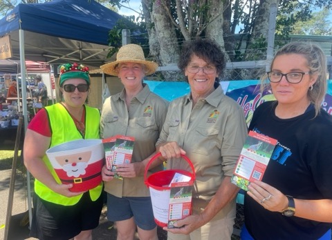 Volunteers with charity buckets at a festive market day
